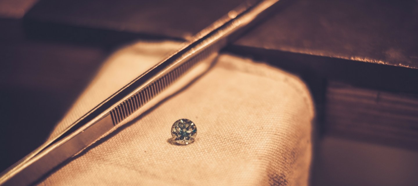 Brilliant cut GIA_graded 2 carat diamond on workbench